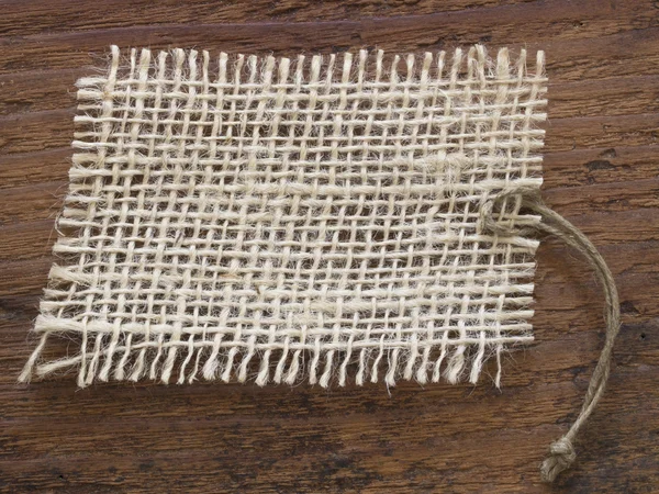 Etiqueta têxtil no fundo de madeira — Fotografia de Stock