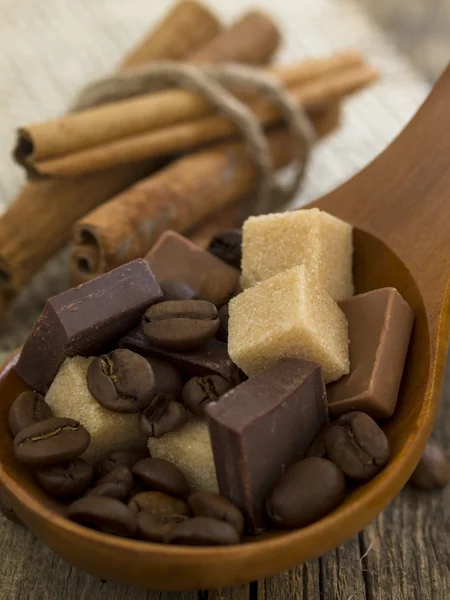 Chocolate bars with sugar cubes and coffee beans — Stock Photo, Image