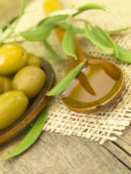 Olives with olive's oil in the spoon — Stock Photo, Image