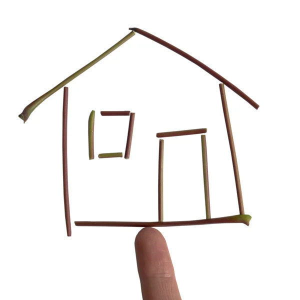 Una casa hecha de pequeñas ramas en el dedo — Foto de Stock