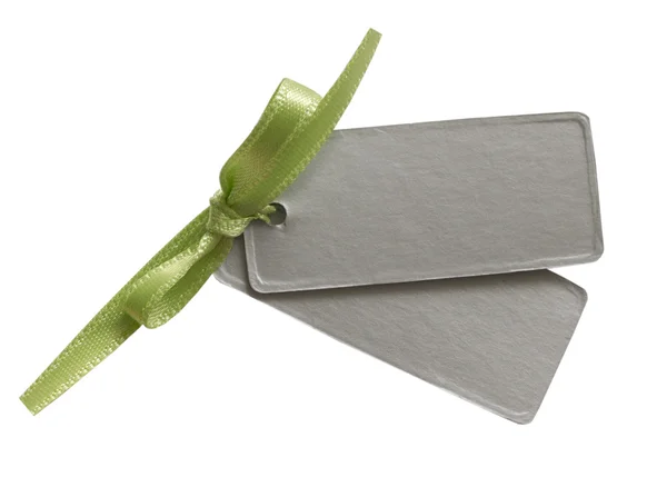 Gray tag with green bow — Stock Photo, Image