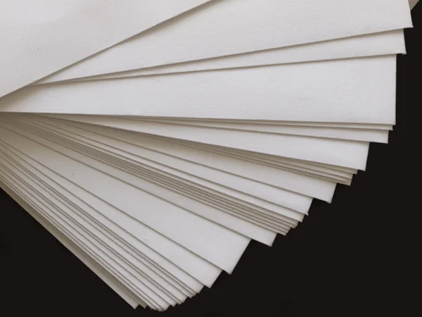 Stack of plain paper on black — Stock Photo, Image