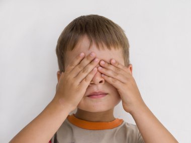 Young boy with hands on his eyes clipart