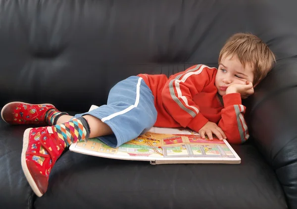 Boy lies on bad. It's a boring day — Stock Photo, Image