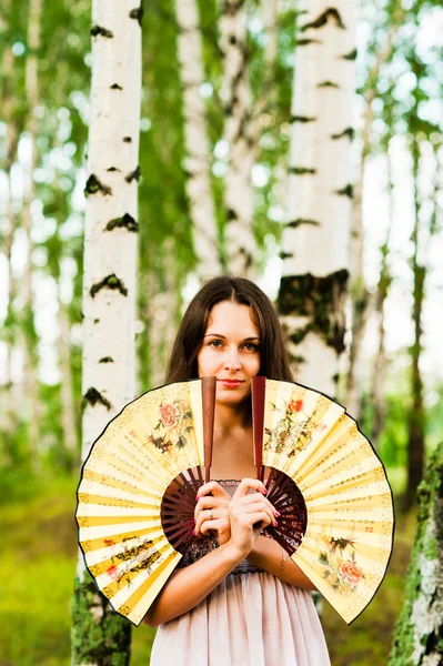 Beautiful woman with two fans — Stock Photo, Image