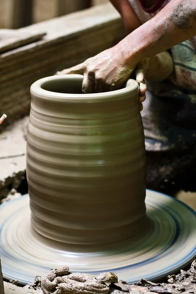 stock image Potter's wheel and hands of craftsman hold a jug.