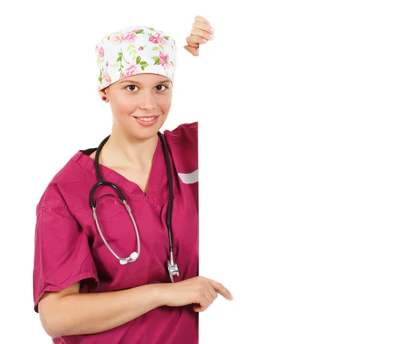 Female doctor pointing on a blank board — Stock Photo, Image