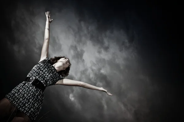 stock image Girl stretching arms into the sky