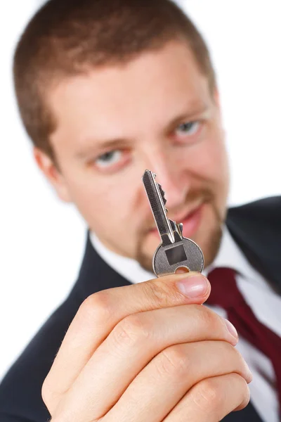 Бизнесмен, держащий ключ — стоковое фото