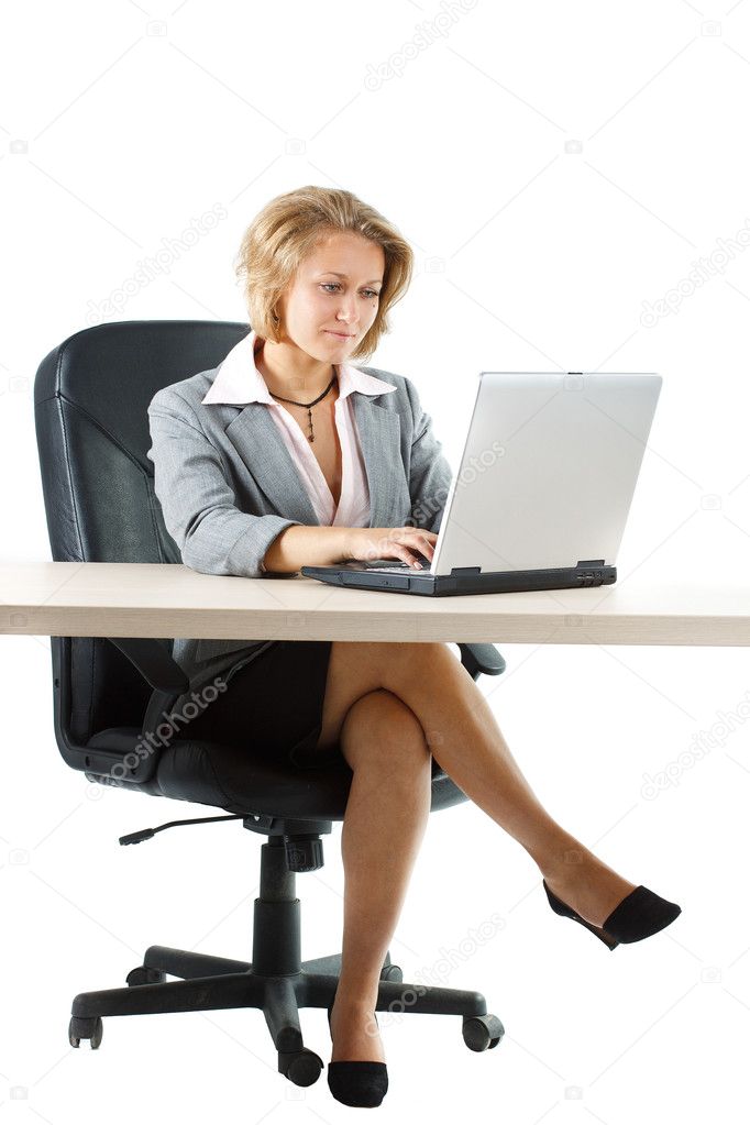 Businesswoman working behind desk over white background