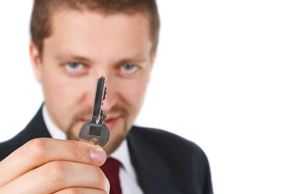 Empresário segurando uma chave — Fotografia de Stock