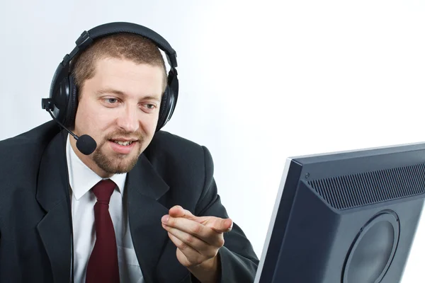 Man with headset showing monitor — Stock Photo, Image