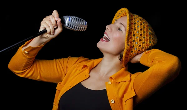 Young woman funky singer over black background — Stock Photo, Image
