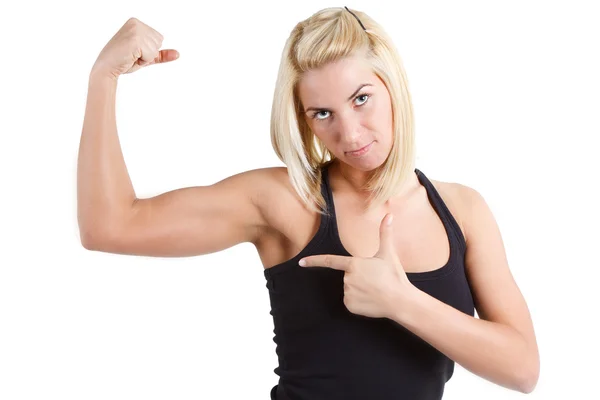 Sportswoman pointing at her muscle — Stock Photo, Image
