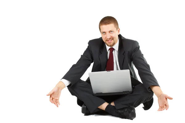 Empresário indefeso com laptop no colo, estendendo os braços — Fotografia de Stock