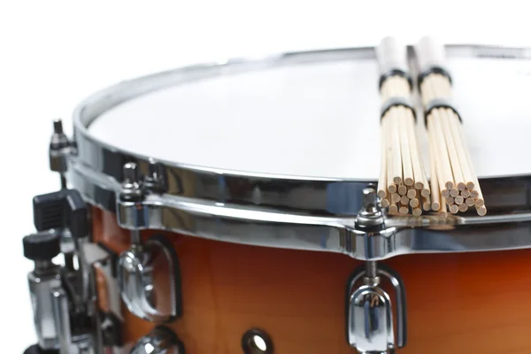 Unplugged drumsticks resting on a snare drum — Stock Photo, Image
