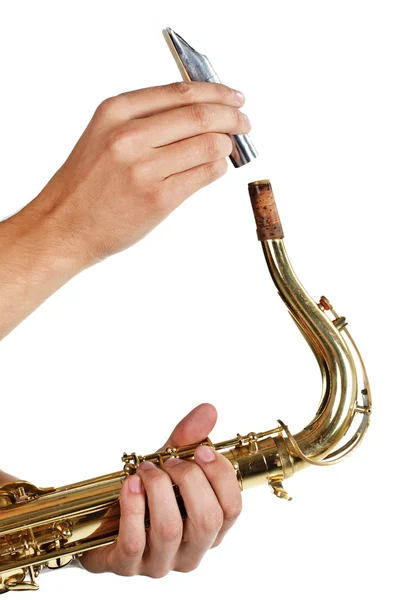 stock image Man putting the mouthpiece back on the saxophone over white background