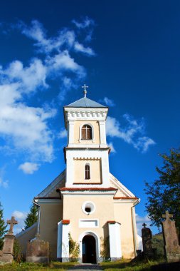 Village church with blue sky clipart