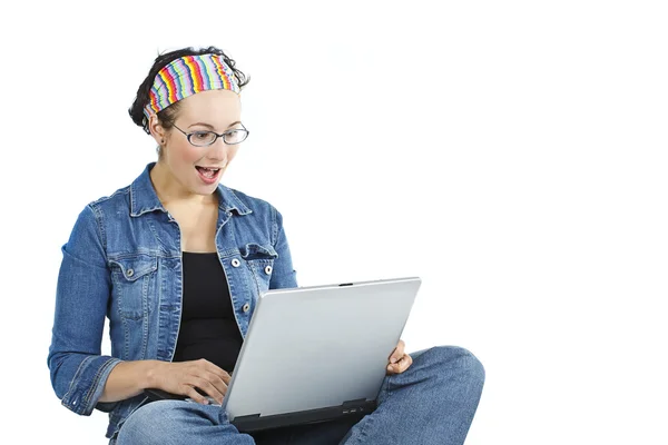 Isolate studio shot of a casually dressed young adult woman gaping at the notebook — Stock Photo, Image