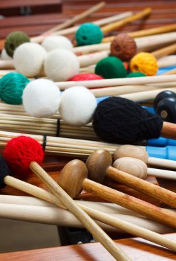 Pile of colored mallets and sticks clipart