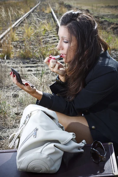 Closeup of an attractive woman applying lipstick — Stock Photo, Image