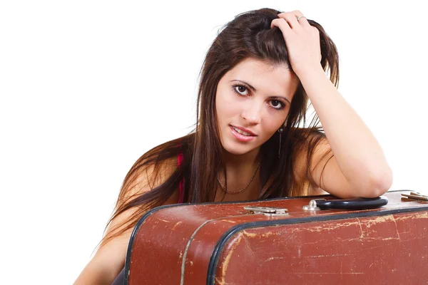 Beautiful young woman leaning on old suitcase — Stock Photo, Image