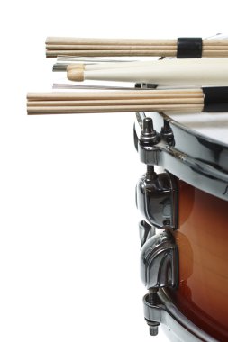 Drumsticks resting on a snare drum clipart