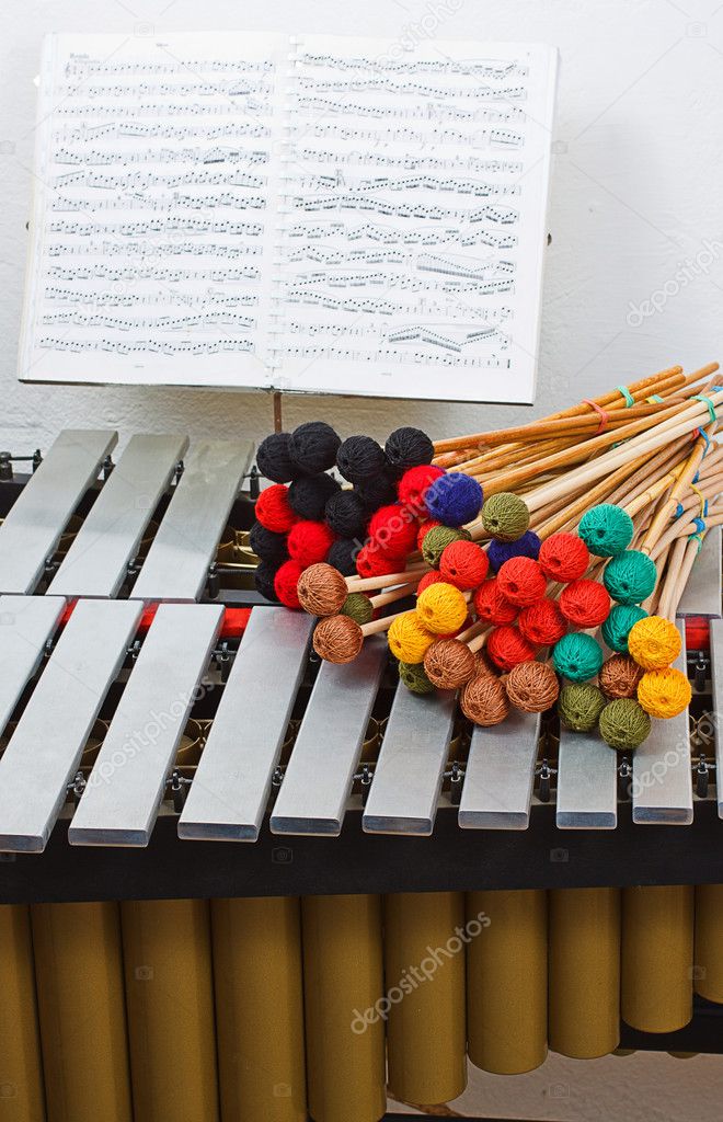 Marimba with colored mallets and musical notes