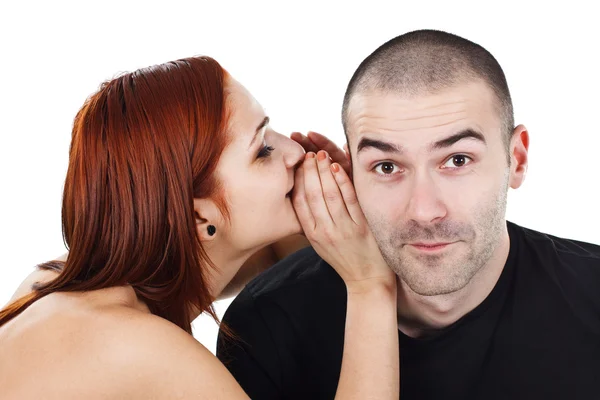 Woman whispering into man`s ear — Stock Photo, Image