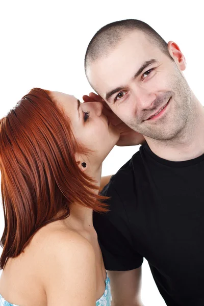 Woman whispering into man`s ear — Stock Photo, Image