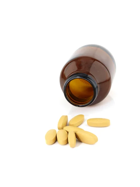 Vitamin C pills spilling from bottle — Stock Photo, Image