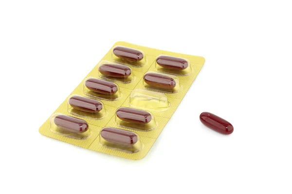 Red capsules packed in blister — Stock Photo, Image