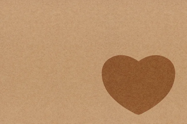 Símbolo do coração sobre papel reciclado — Fotografia de Stock