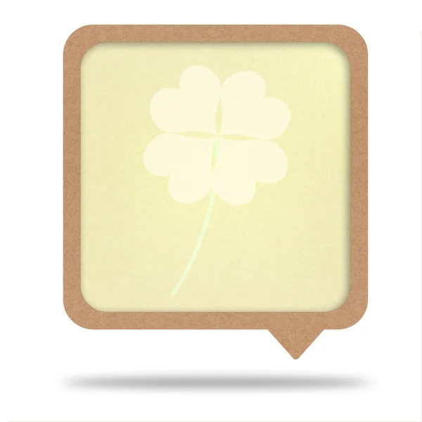 Clover with four leaves on recycle paper talk tag — Stock Photo, Image