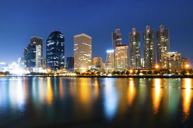 Angkok city downtown at night with reflection of skyline, Bangko clipart