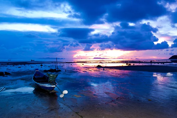 Vene rannalla auringonlaskun aikaan — kuvapankkivalokuva