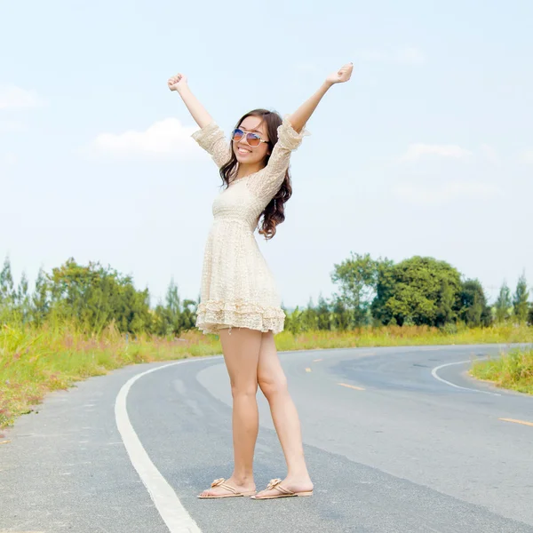 stock image Young asianwoman stan on the road in a happy feel.