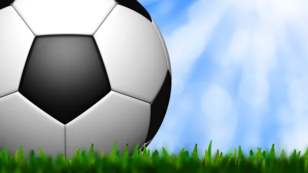 Футбол в зеленой траве над небом — стоковое фото