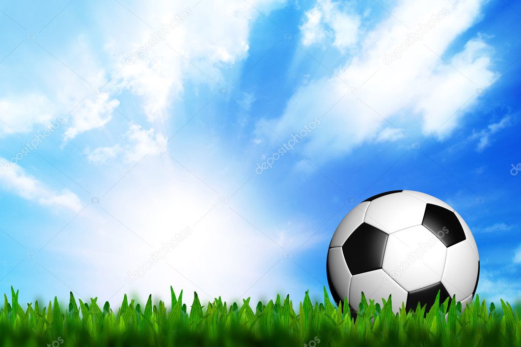 3D football in green grass on blue sky
