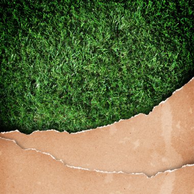 Recycled paper on grass background. clipart