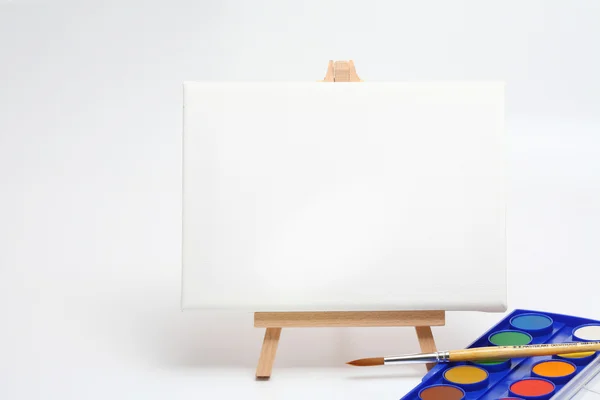 Easel with brush and watercolors — Stock Photo, Image