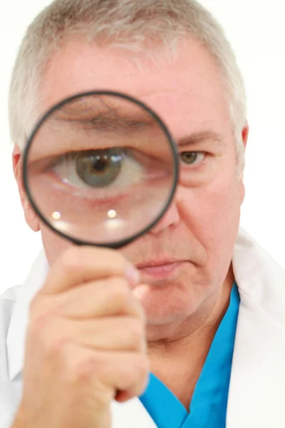 stock image Man looking into a magnifying glass