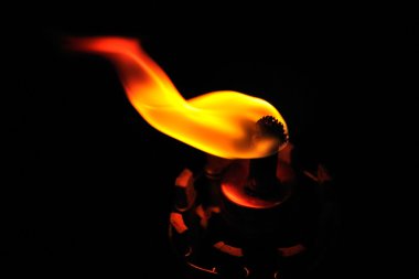 Close up of the flame of an oil lamp clipart