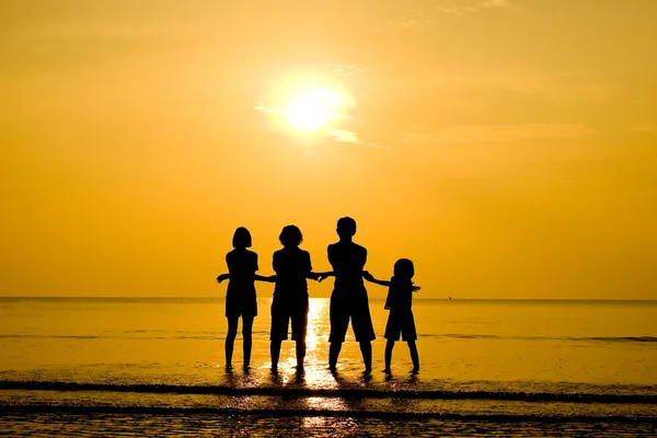 Funny family silhouette on the beach — Stock Photo, Image