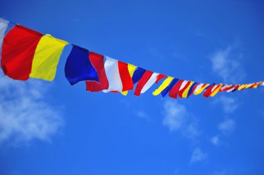 Budhist's flag in the sky clipart