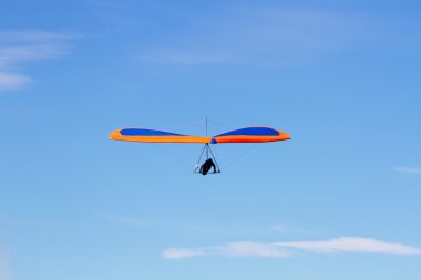 Hang Gliding on a Blue Sky clipart