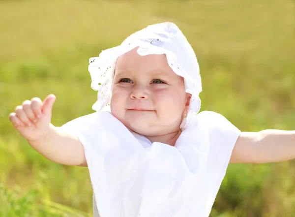 Smiling baby girl showing finger up — Stock Photo, Image