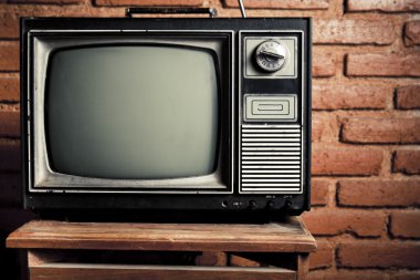 Retro grunge tv against brick wall. clipart