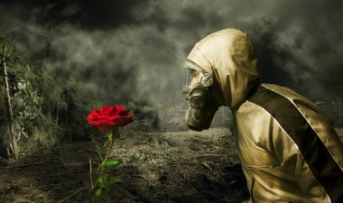 Man in a gas mask with a rose