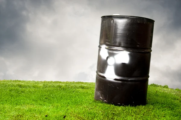 Contaminating drum barrel on grass to represent pollution — Stock Photo, Image